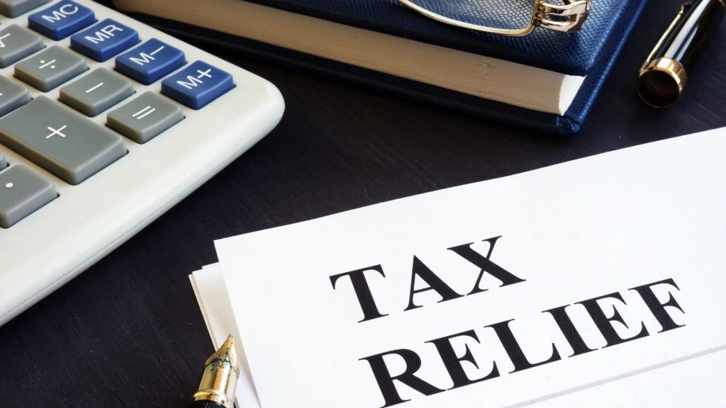 Tax relief concept Calculator note pad and pen